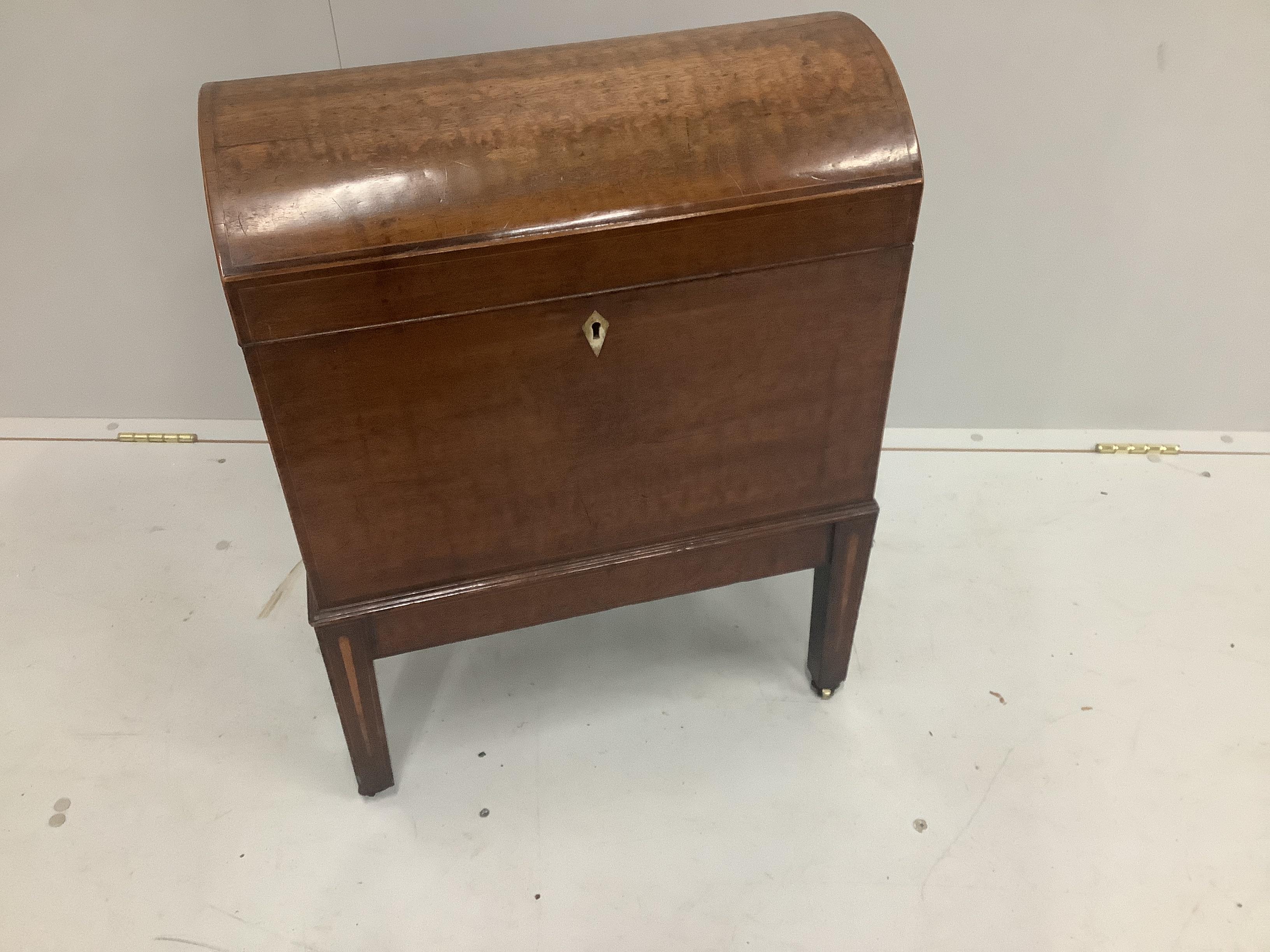 A George III mahogany cellarette with hinged domed cover and brass carrying handles, raised on a fixed stand and castors, ivory lock escutcheon, width 53cm, height 68cm, CITES Submission reference: WYX11111